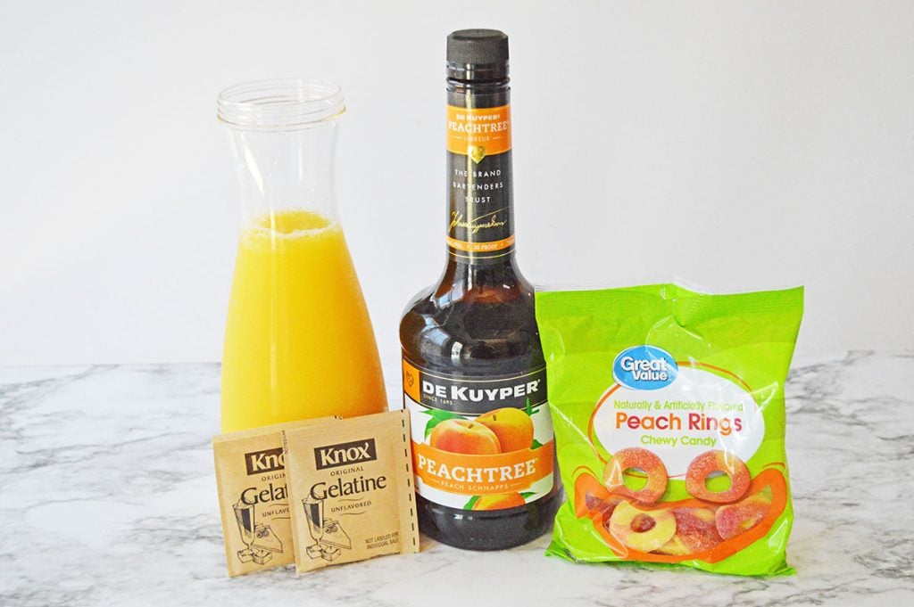 orange juice, gelatin, peach schnapps laid out to make fuzzy navel jello shots.