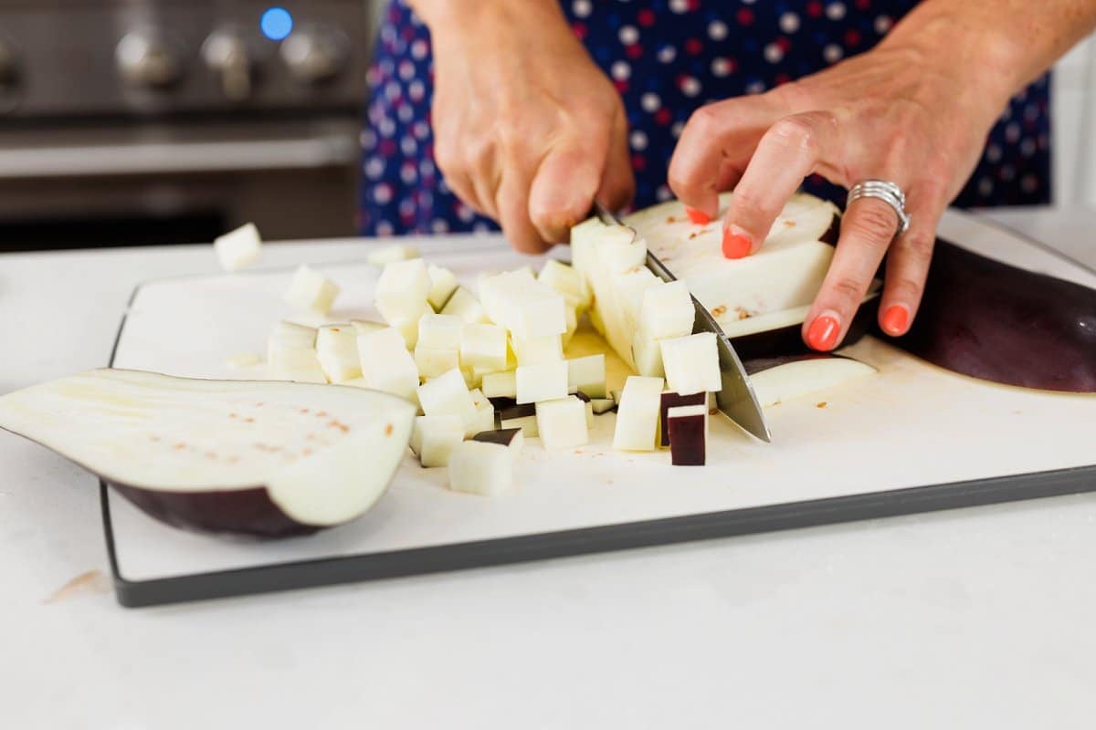 Liz cutting an eggplant into cubes.