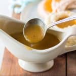 spoon lifting turkey gravy from a gravy boat.