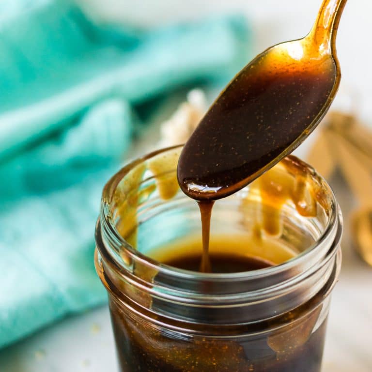 spoon lifting from a jar of homemade teriyaki sauce.