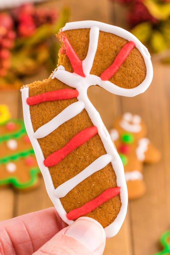 candy cane gingerbread cookie with a bite missing.