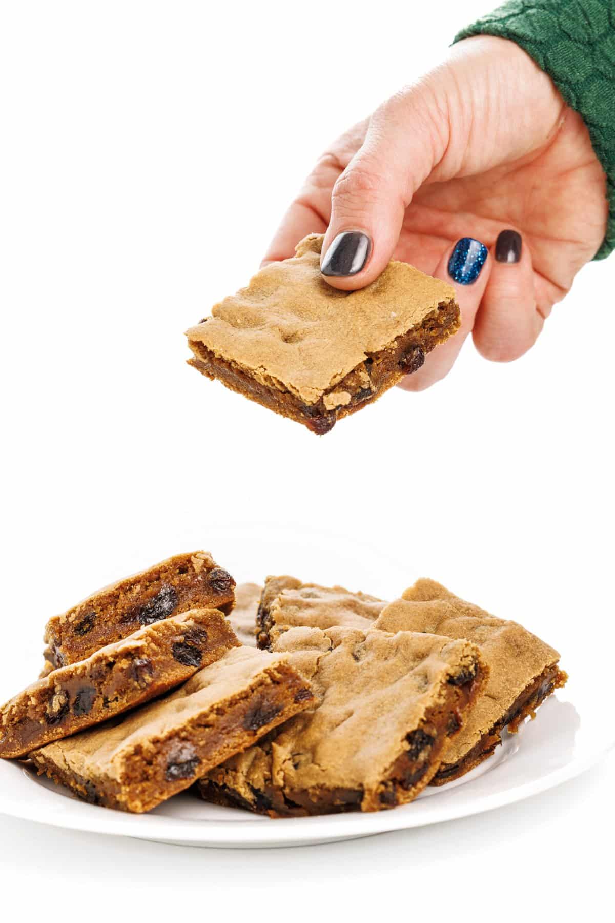 Picking up a New England hermit cookie bar off of a plate.