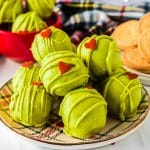 plate of green grinch oreo balls with a heart shaped sprinkle.