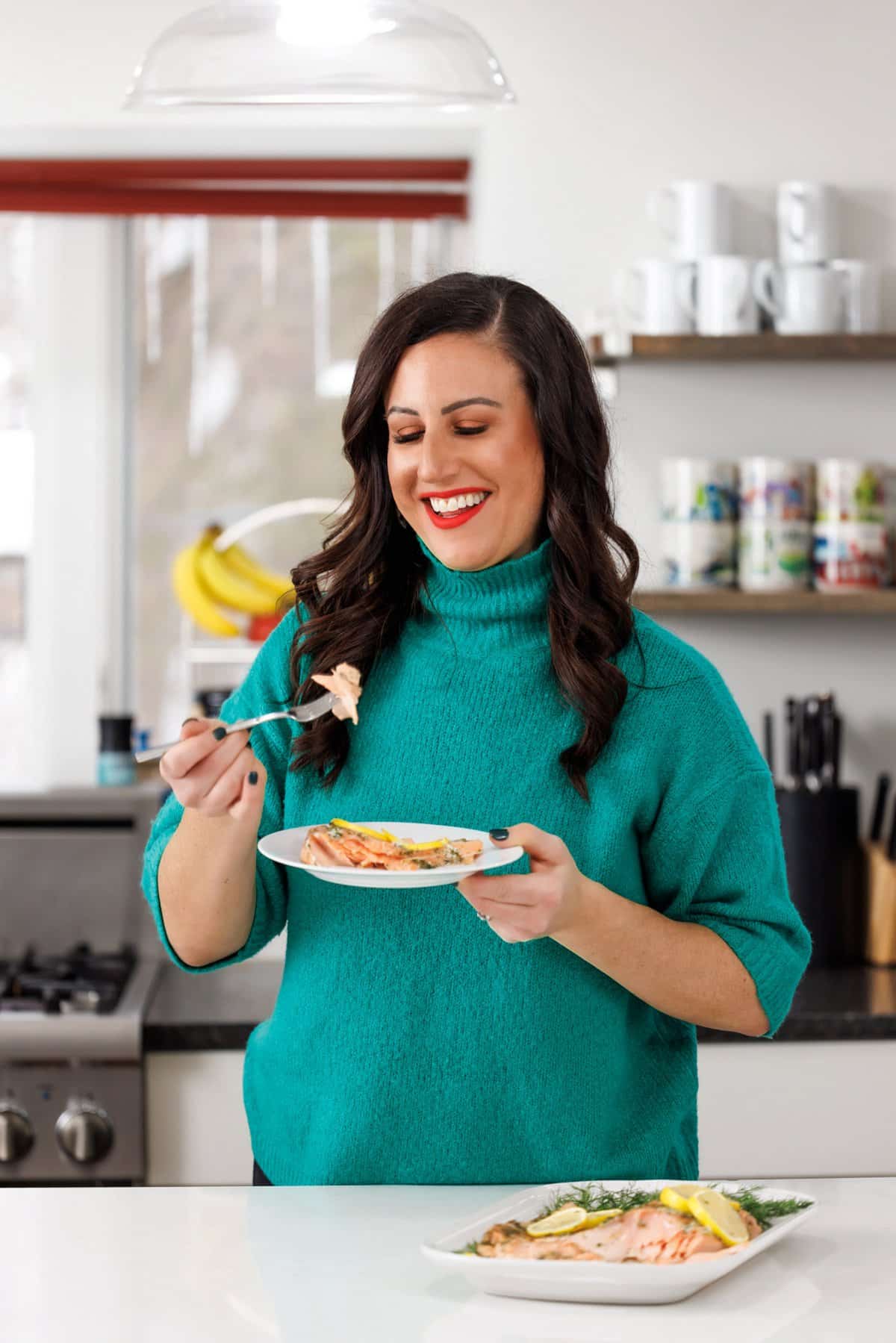 Liz eating garlic and dill roasted salmon.