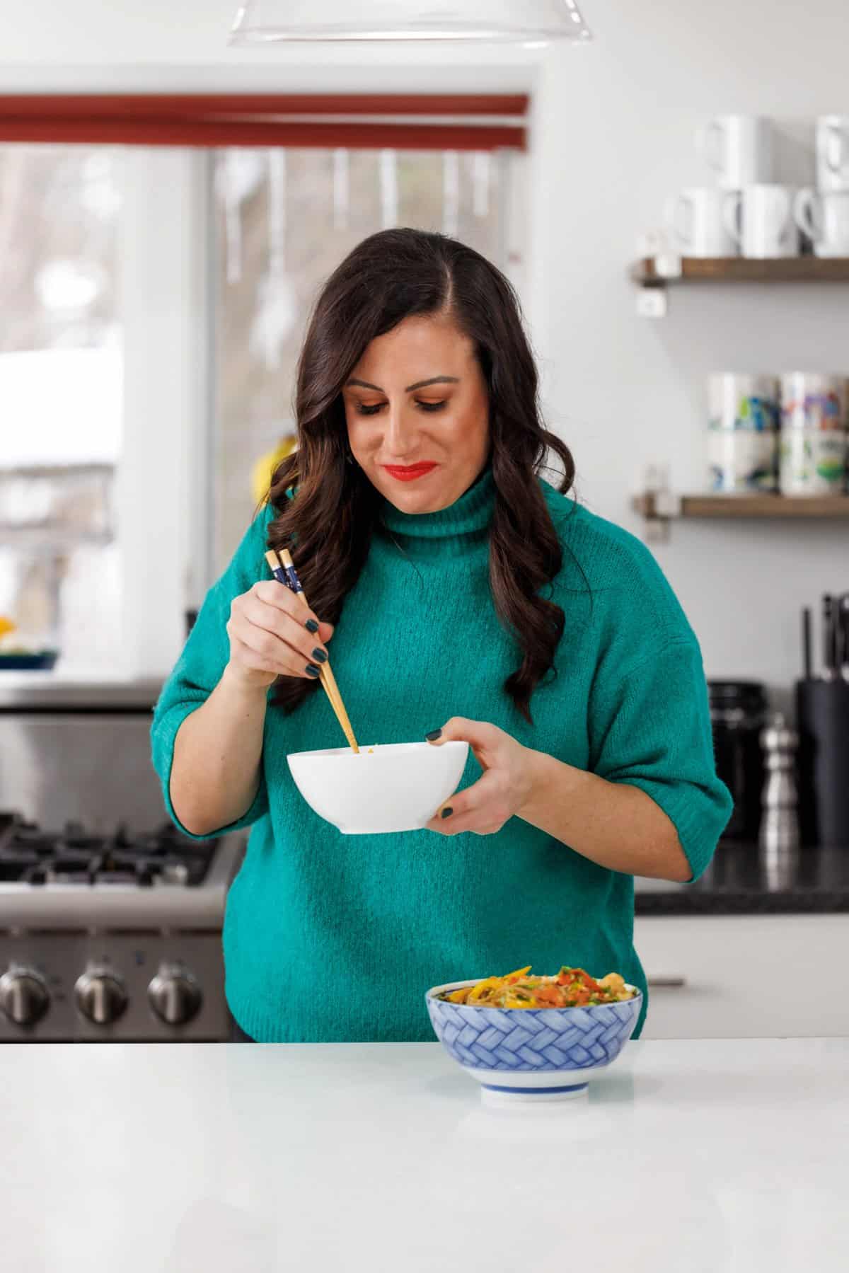 Liz eating shrimp soba noodles in peanut sauce.