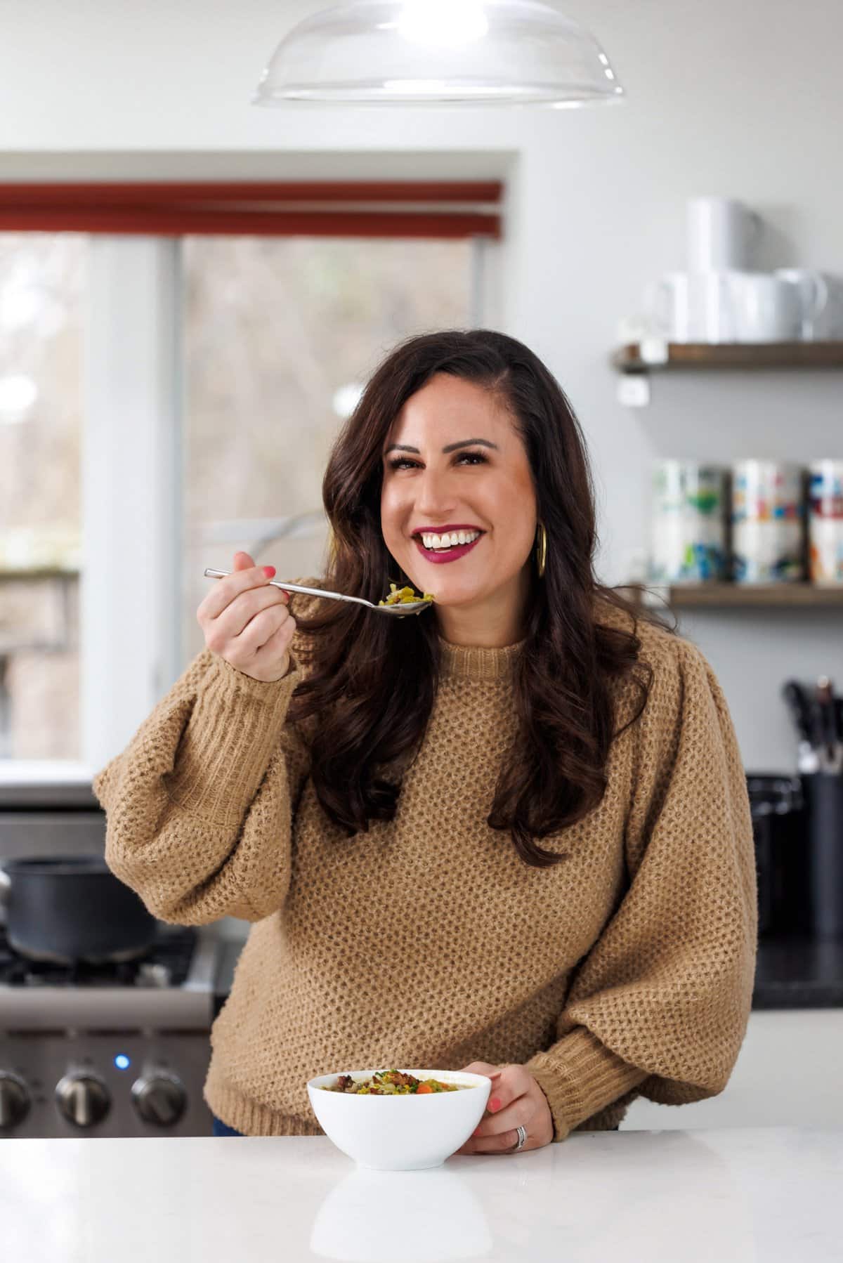 Liz eating slow cooker split pea and bacon soup.