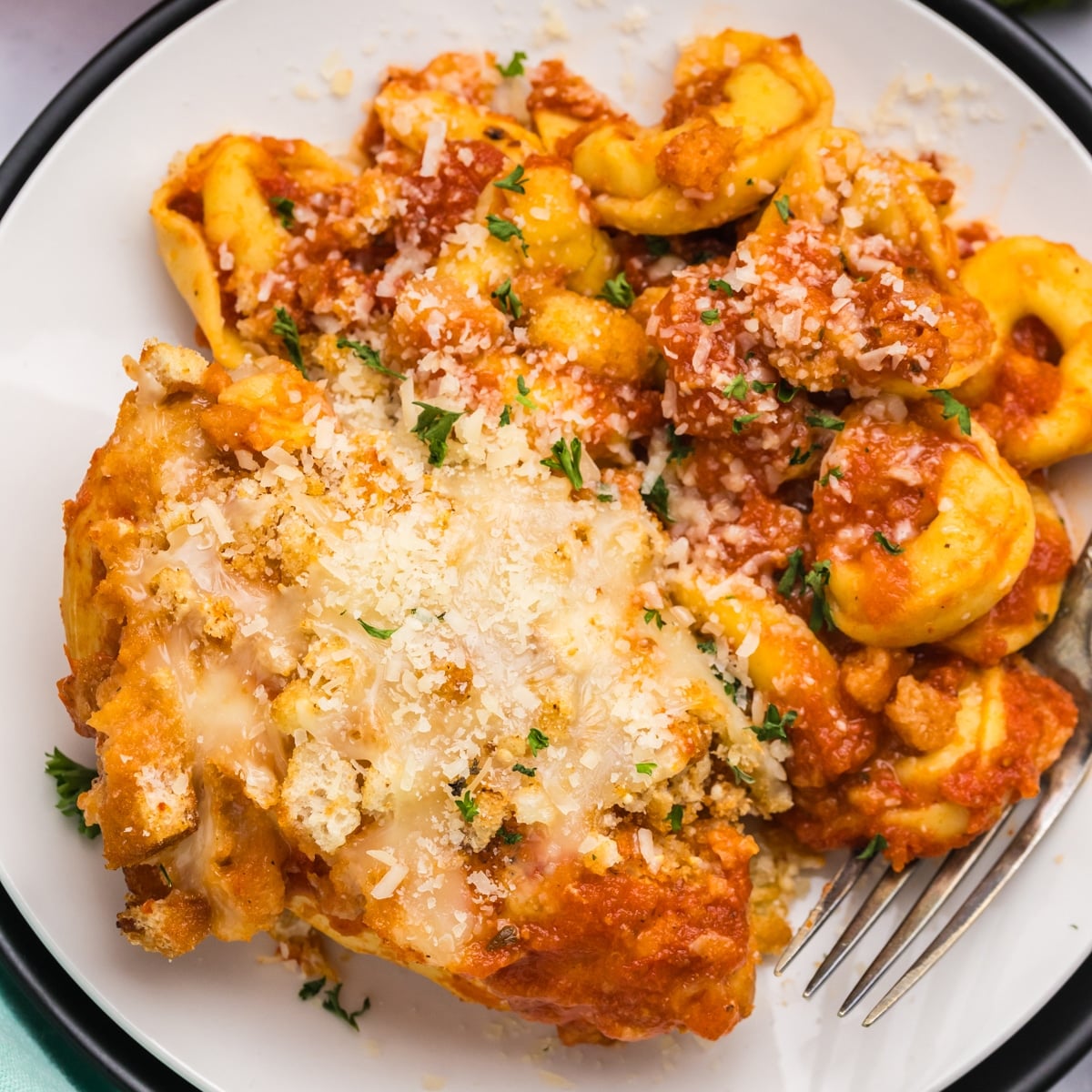 overhead shot of plated chicken parmesan with tortellini.