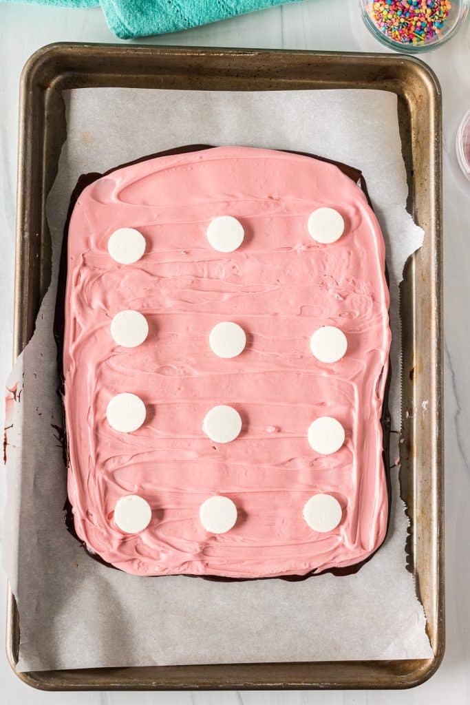 pink candy bark with white chocolate disks.