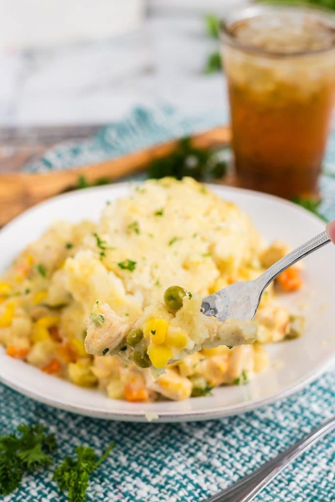 fork lifting a bite of chicken cobbler.