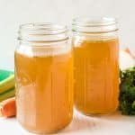 two mason jars filled with homemade chicken stock.