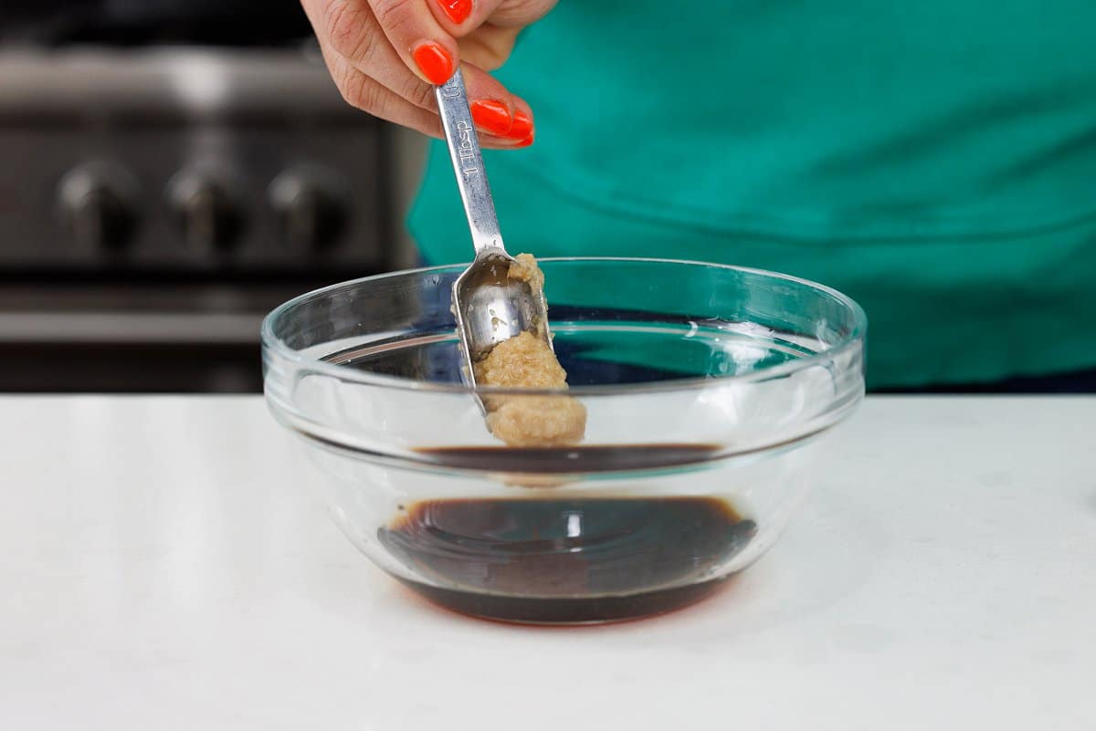 Adding ginger paste to glass bowl.