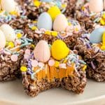 chocolate bird nest cookie with a bite missing showing the peanut butter filling.