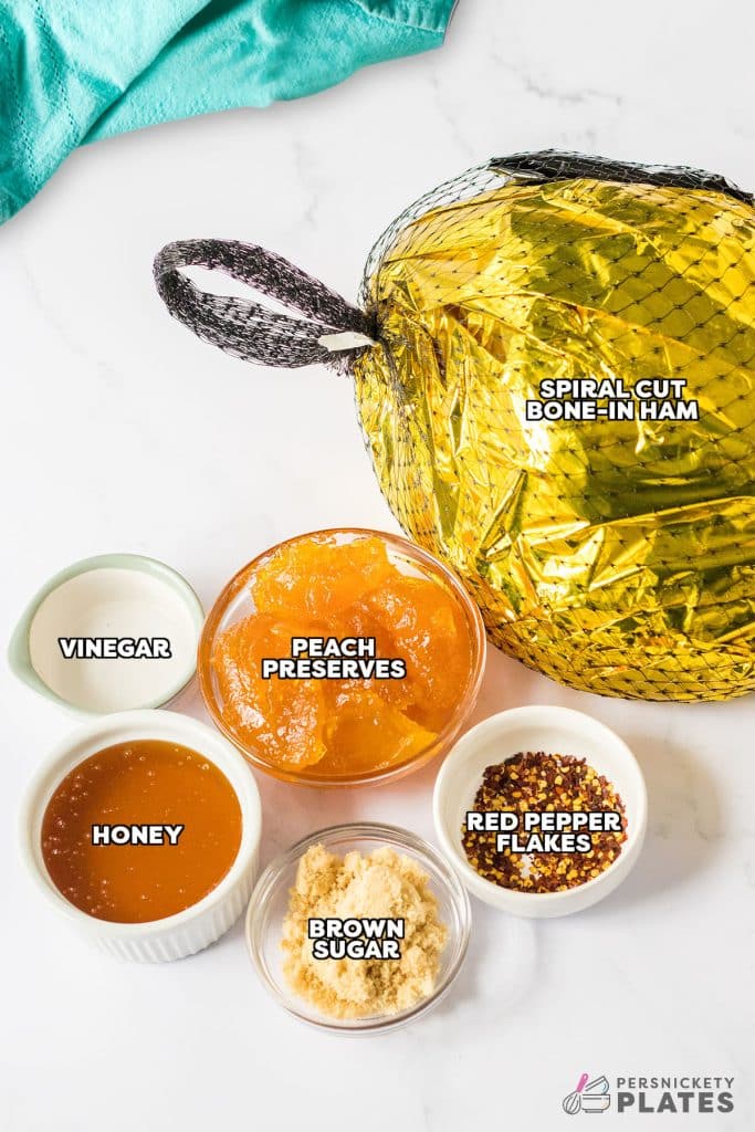 overhead shot of labeled ingredient laid out to make hot honey peach slow cooker ham.