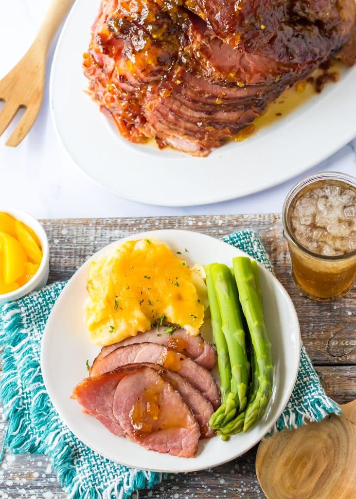 overhead shot of dinner plate with ham, potatoes, and asparagus.
