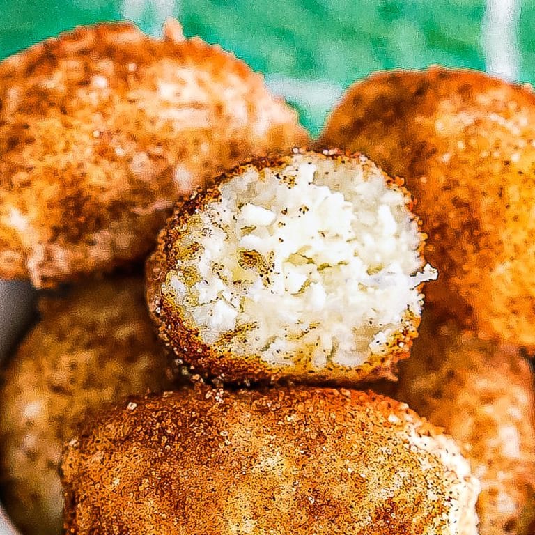 irish potato candy in a bowl with one missing a bite.