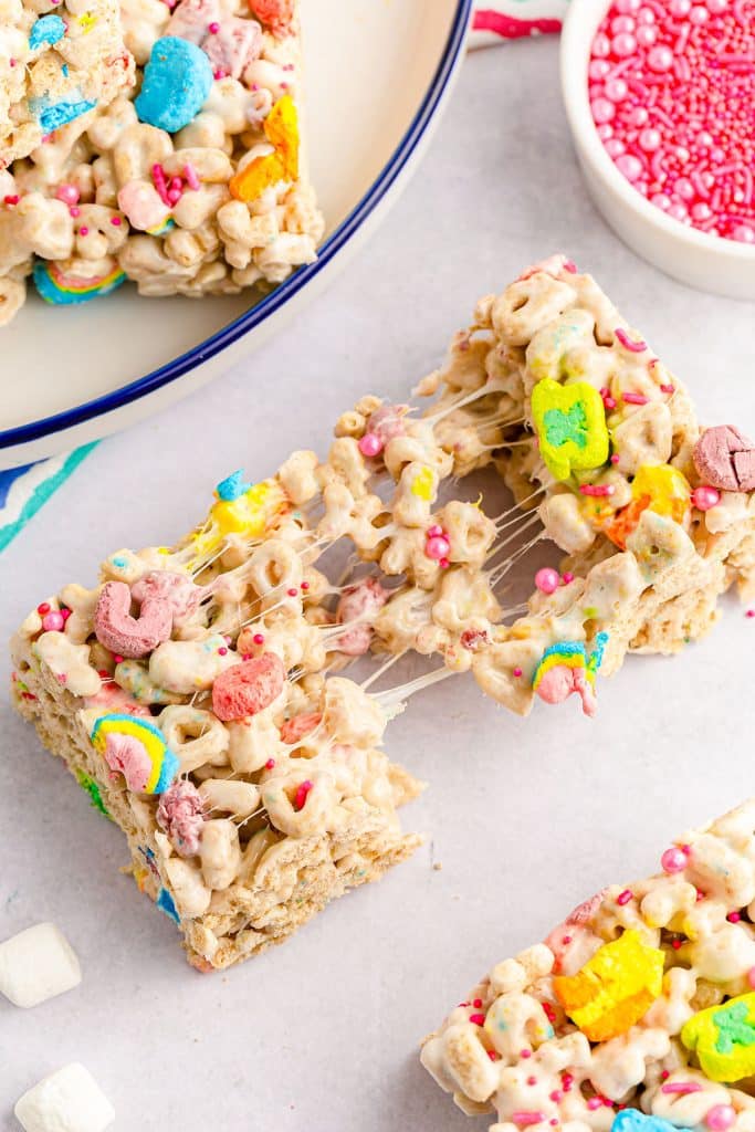 a gooey lucky charms marshmallow bar being pulled apart.