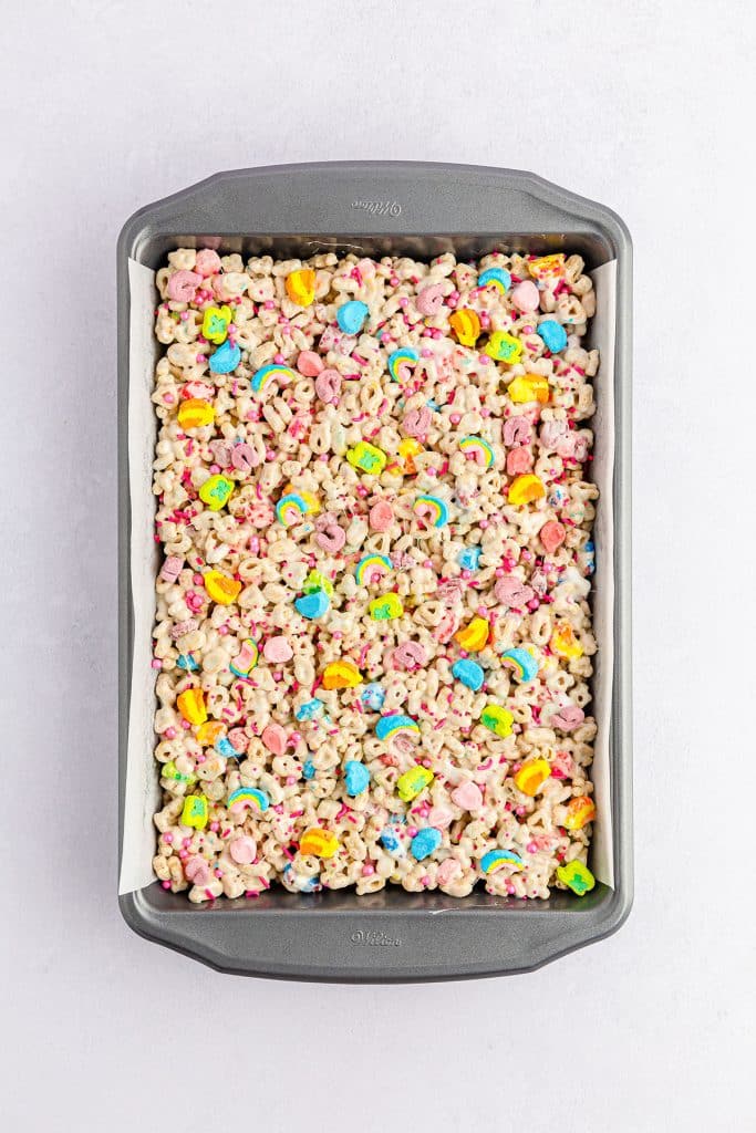 overhead shot of lucky charms treats topped with colorful marshmallows & sprinkles.