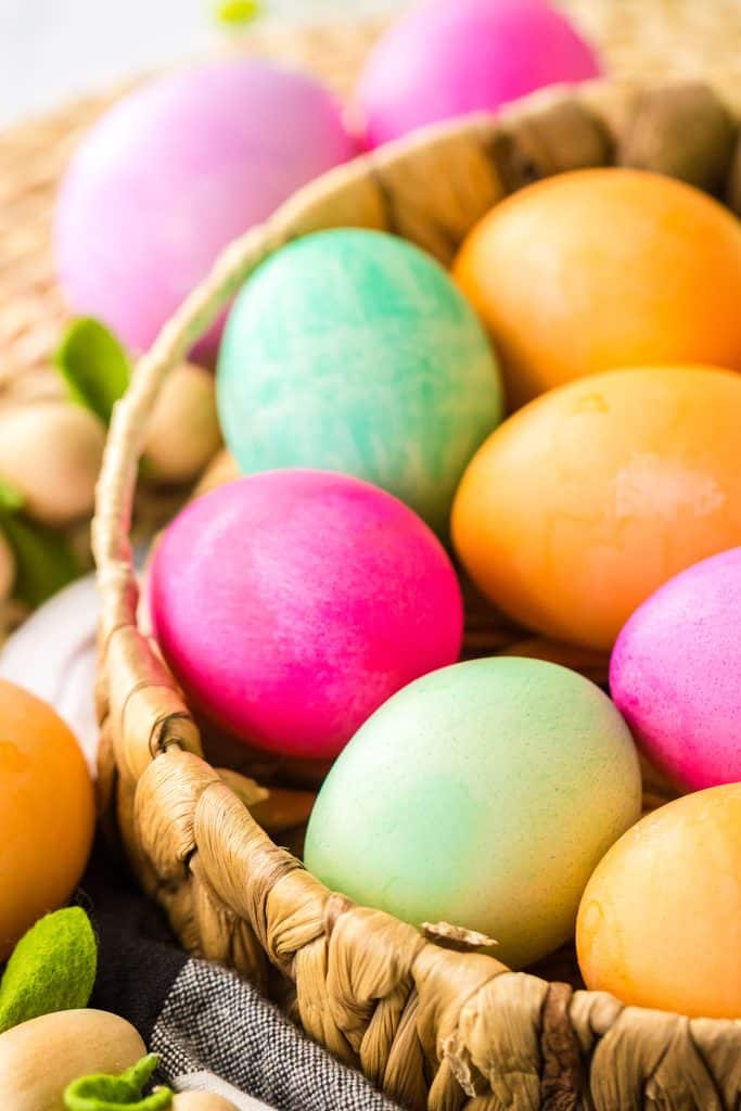 colorful easter eggs in a wicker basket.