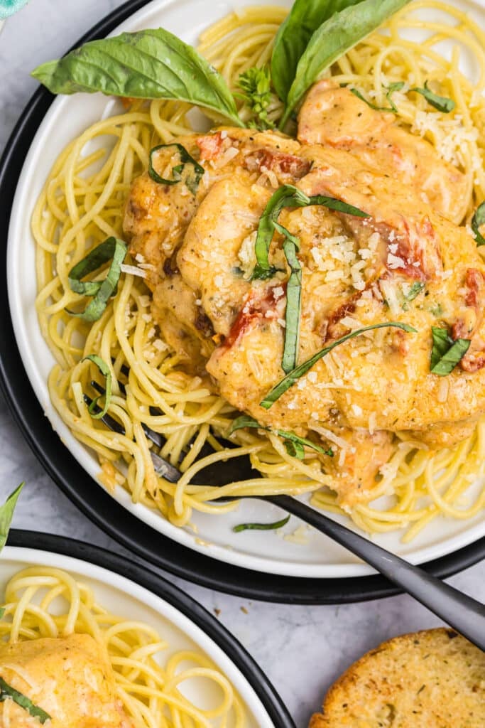 plate of marry me chicken on spaghetti noodles.