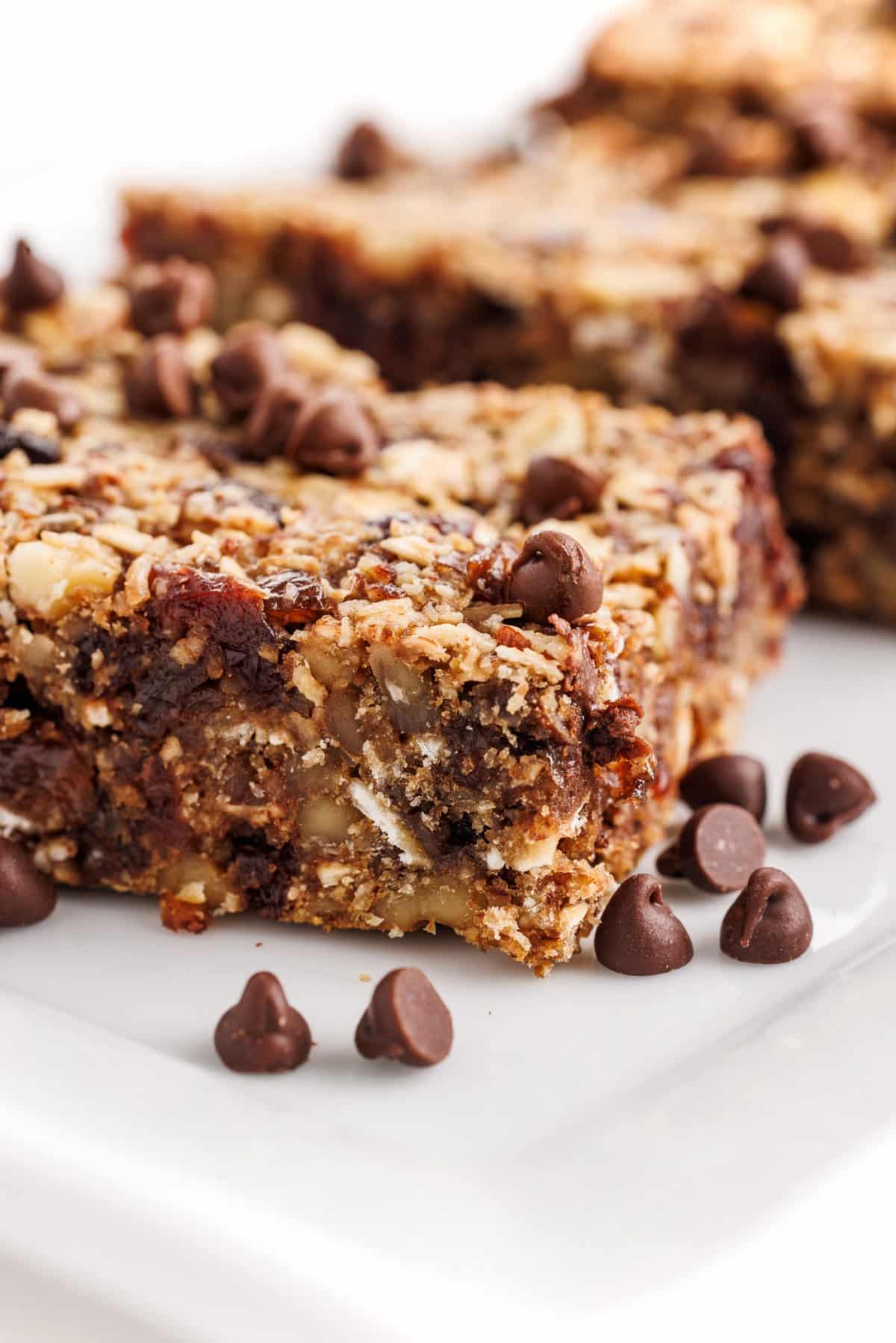 Seedy oat and flax granola bars with chocolate chips on a platter.