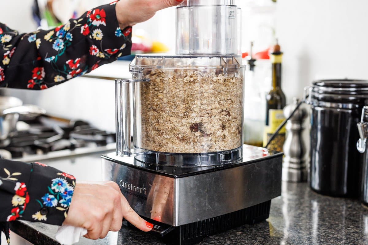 Pulsing granola bar ingredients in food processor.