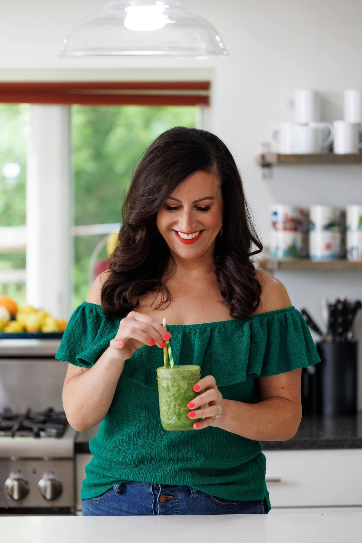 Liz drinking an apple ginger green smoothie.