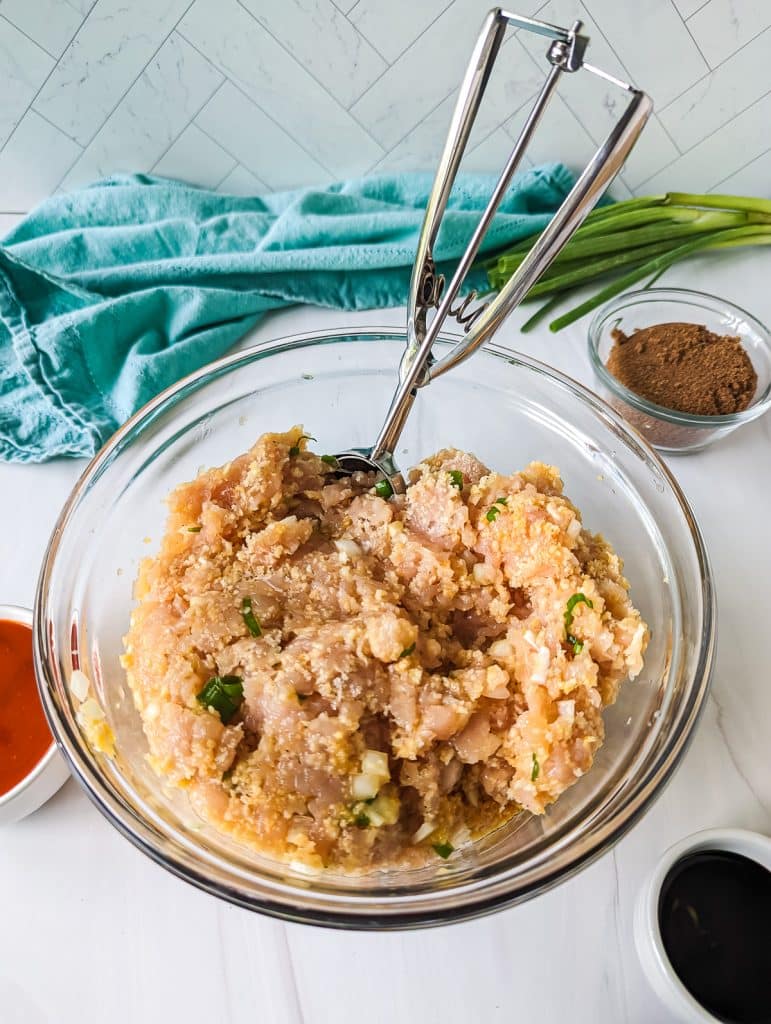 ground chicken meatball mixture in a mixing bowl.