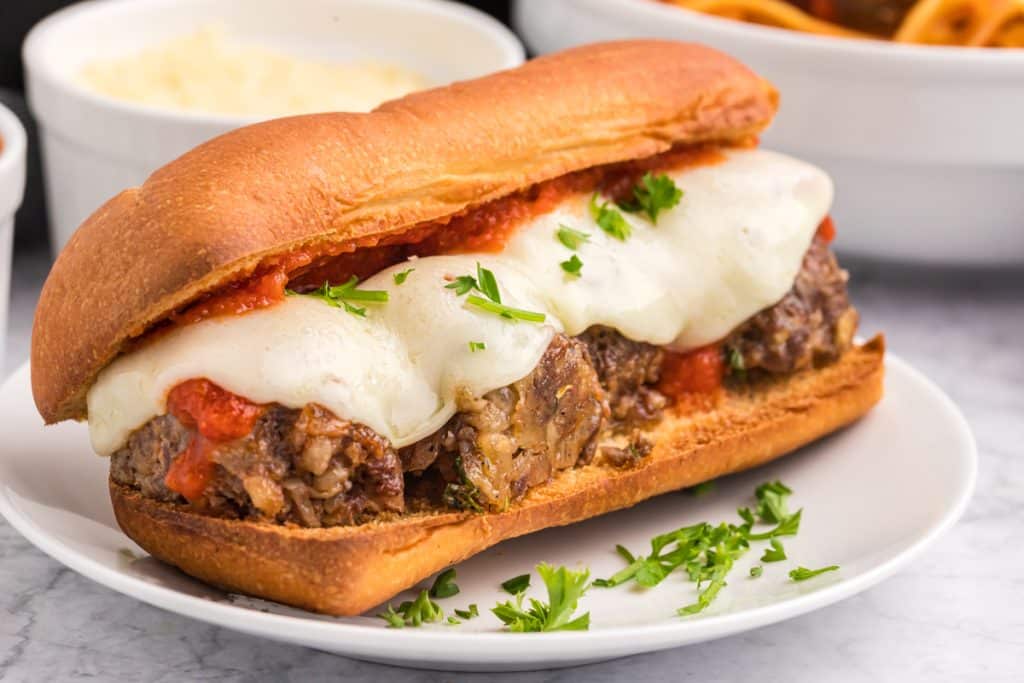 meatball sub on a white plate.