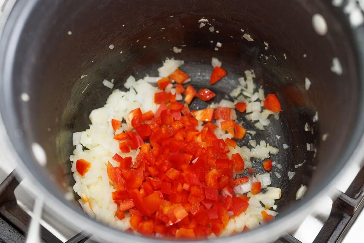 Diced onion and red pepper in the bottom of a large pot.