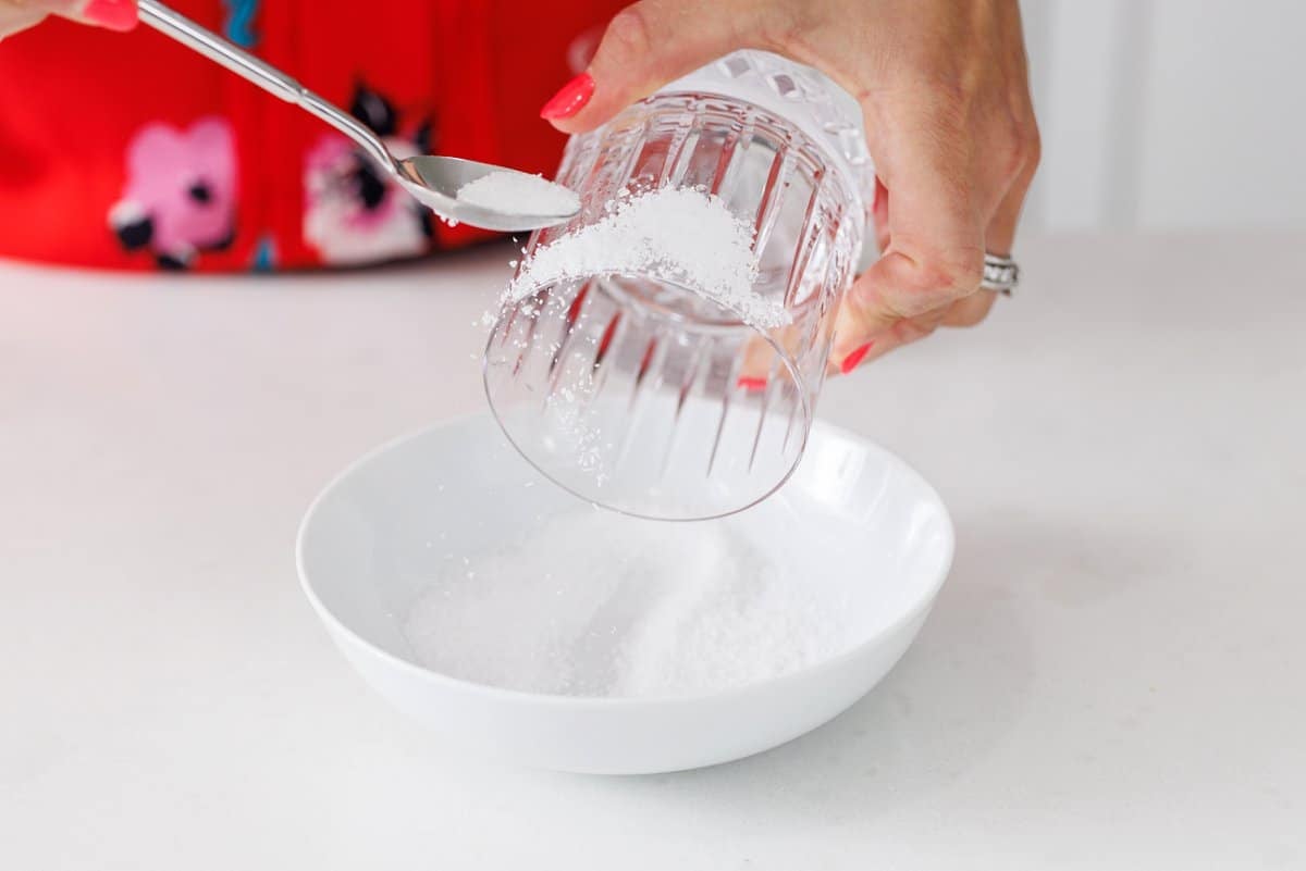 Adding salt to the rim of a glass.