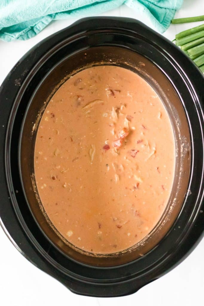 overhead shot of buffalo chicken chili in in a black slow cooker.
