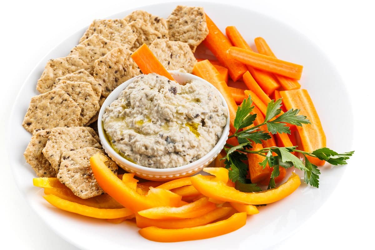 White bean and roasted eggplant dip with veggies and crackers.