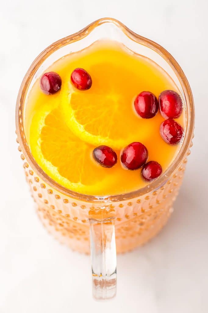 overhead shot of christmas punch in a glass pitcher.