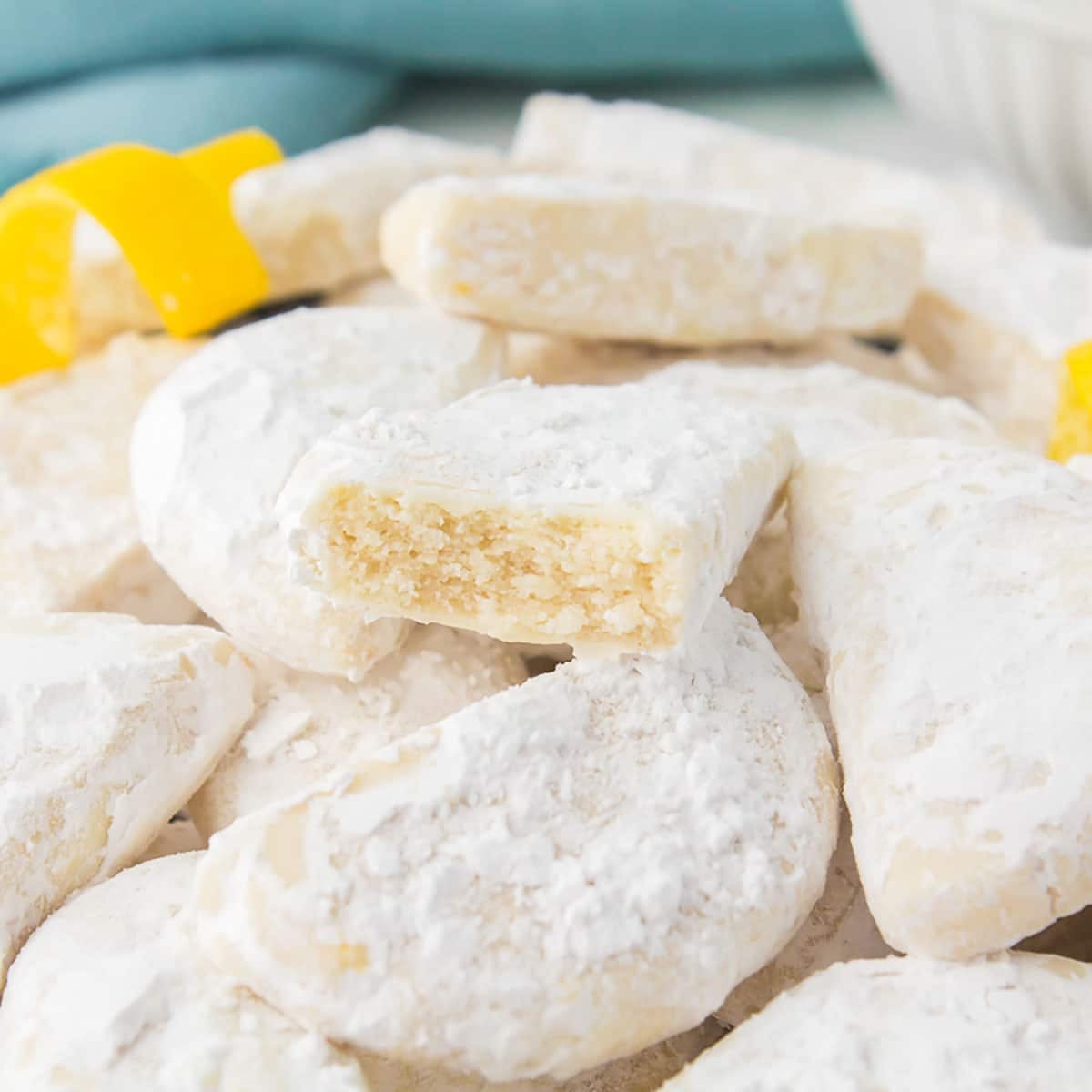 pile of savannah smiles cookies with a bite taken out of one.