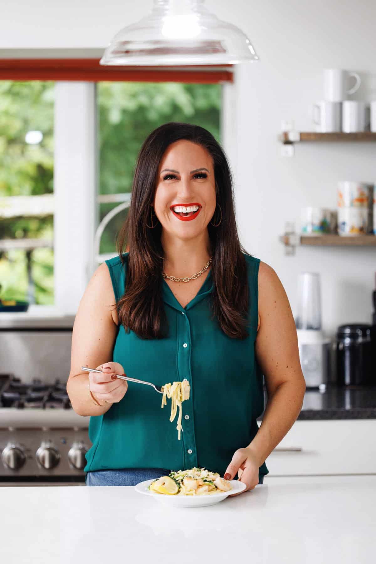 Liz eating lemon shrimp pasta with arugula.
