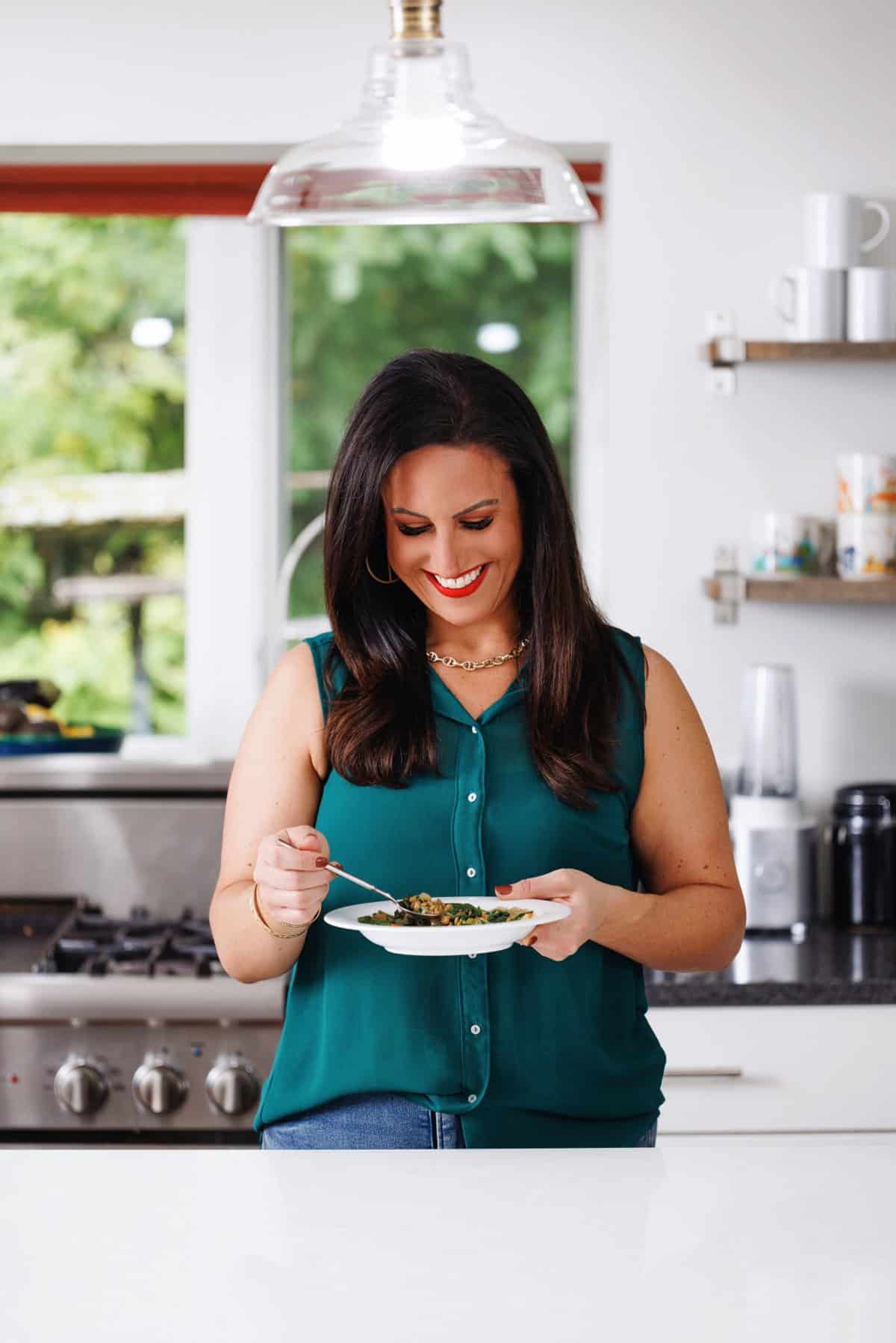 Liz eating Lebanese lentil soup with greens.