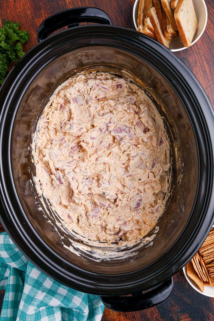 overhead shot of reuben dip in a black crockpot.