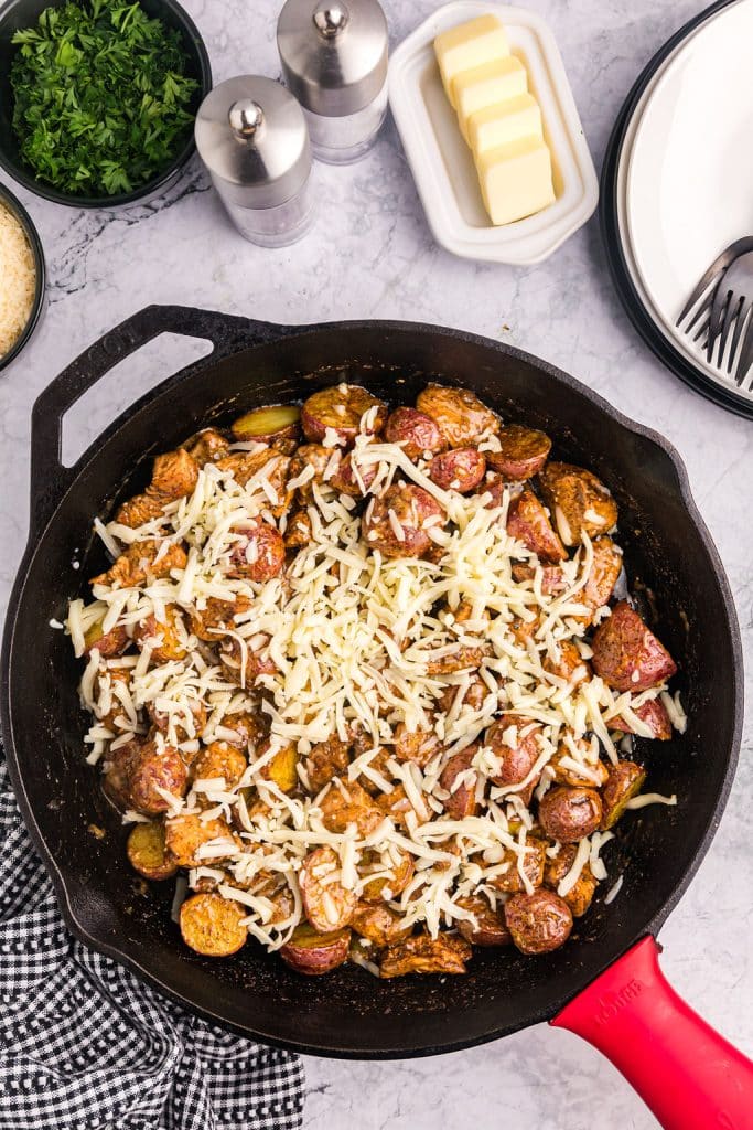 mozzarella cheese sprinkled on a chicken skillet.
