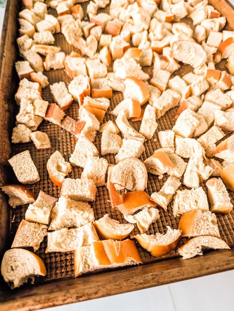 cubed bread on a baking sheet.