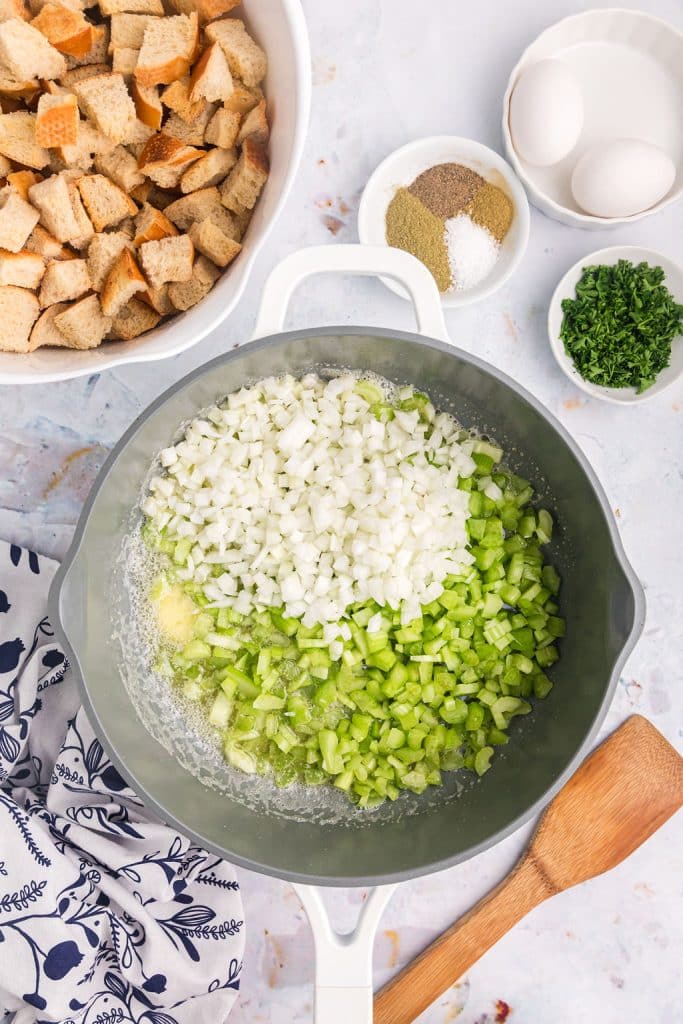 overhead shot of diced celery & onion sauteing in butter.
