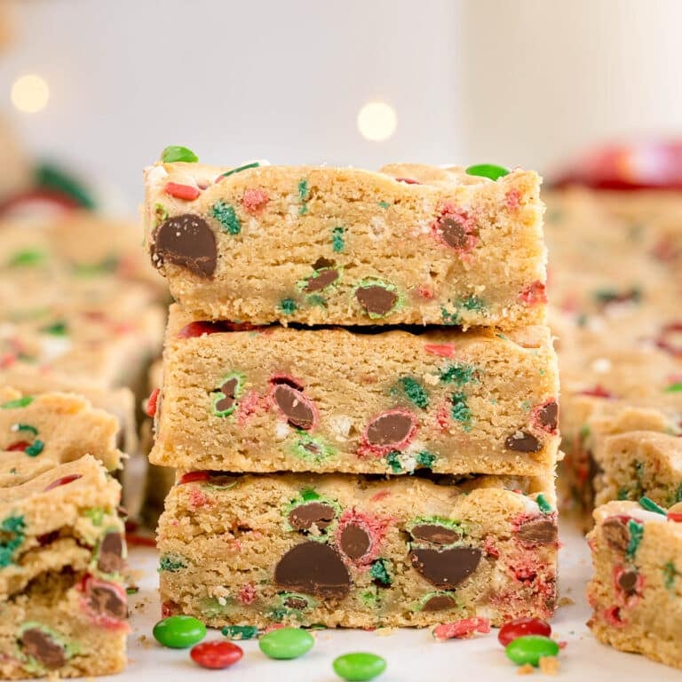 stack of christmas cookie bars with colorful M&Ms and sprinkles.