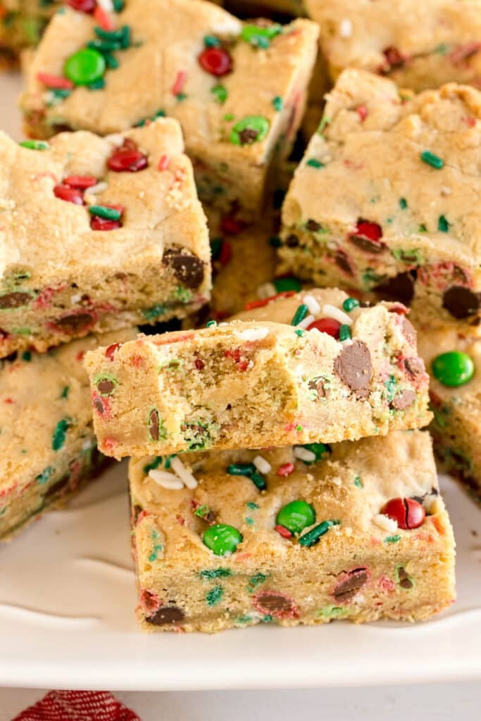 stack of christmas cookie bars with one missing a bite.