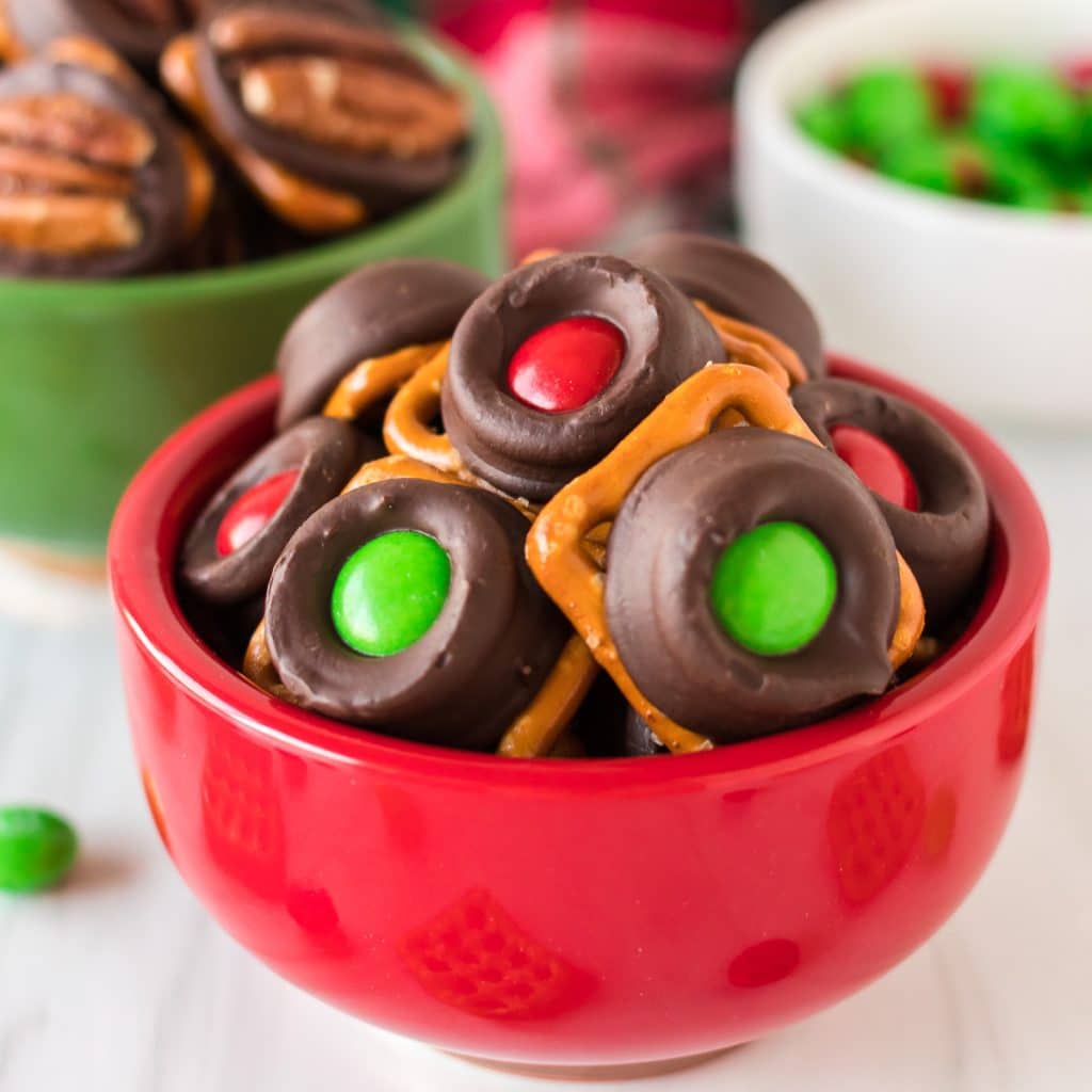 red bowl filled with christmas rolo pretzels.