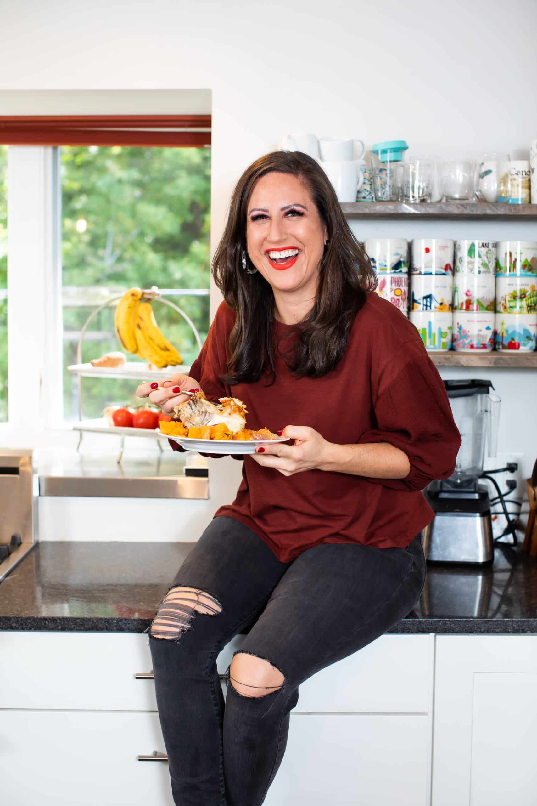 Liz eating baked chicken and sweet potatoes.