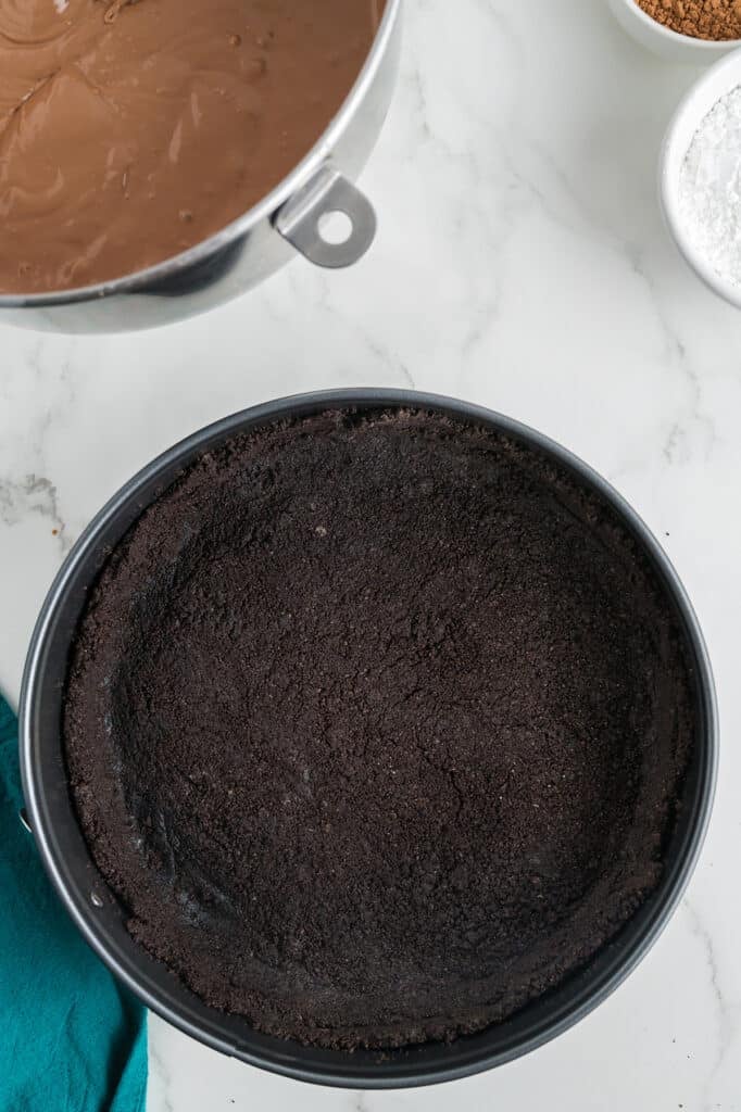 overhead shot of an oreo crust in a pan.