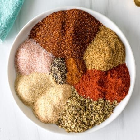 seasonings on a plate to make a homemade chili seasoning blend.