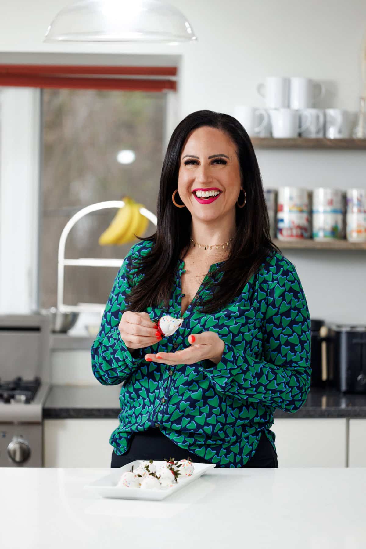 Liz eating frozen yogurt covered strawberries.