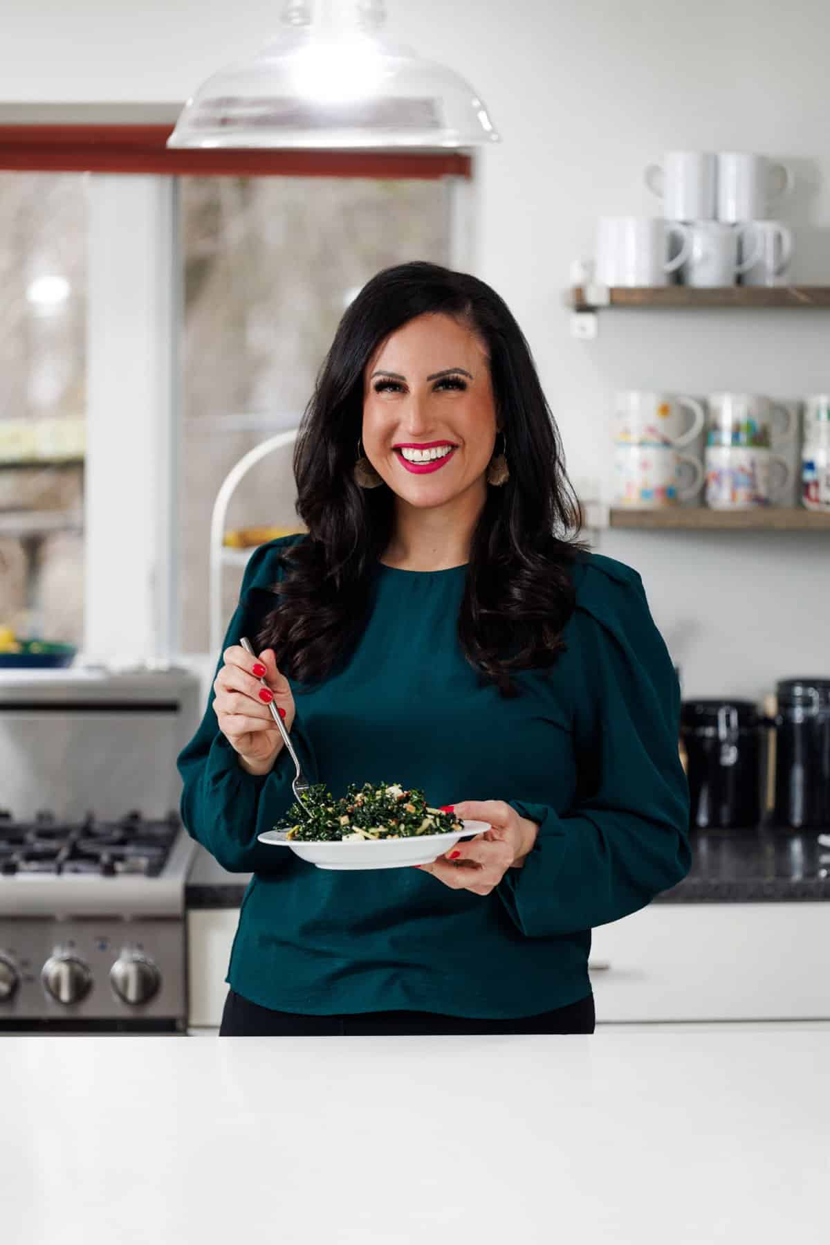 Liz eating kale salad with apples and walnuts.