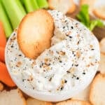 bagel chip dipping into everything bagel dip.