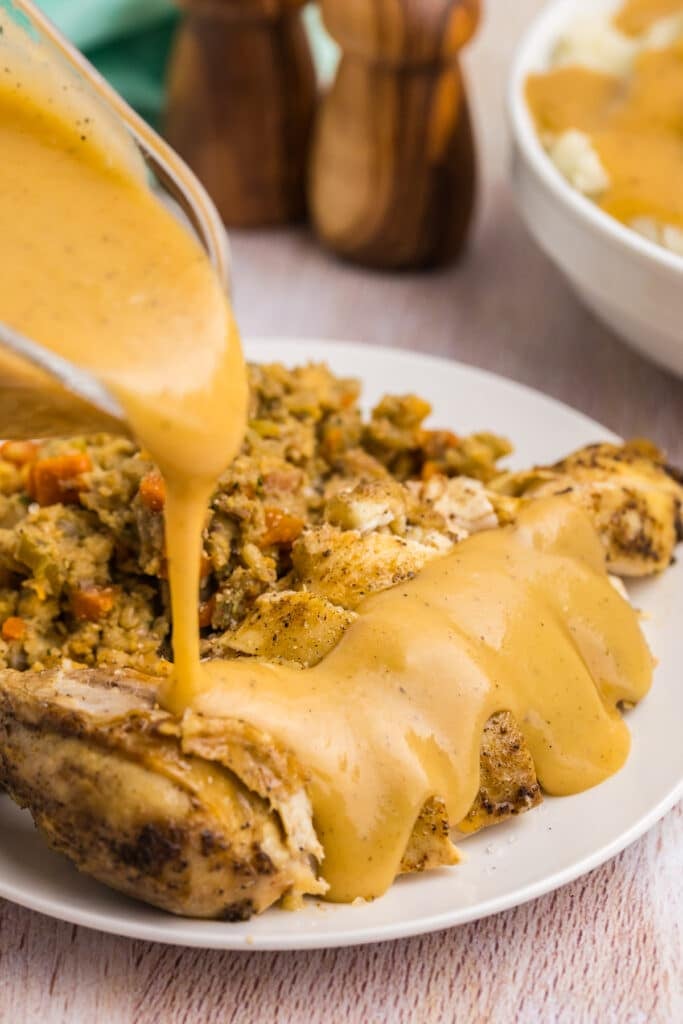 gravy pouring over sliced chicken breast.